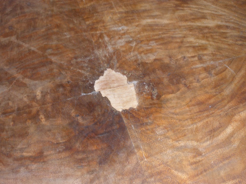 Deeply scratched surface of coffee table prior to restoration
