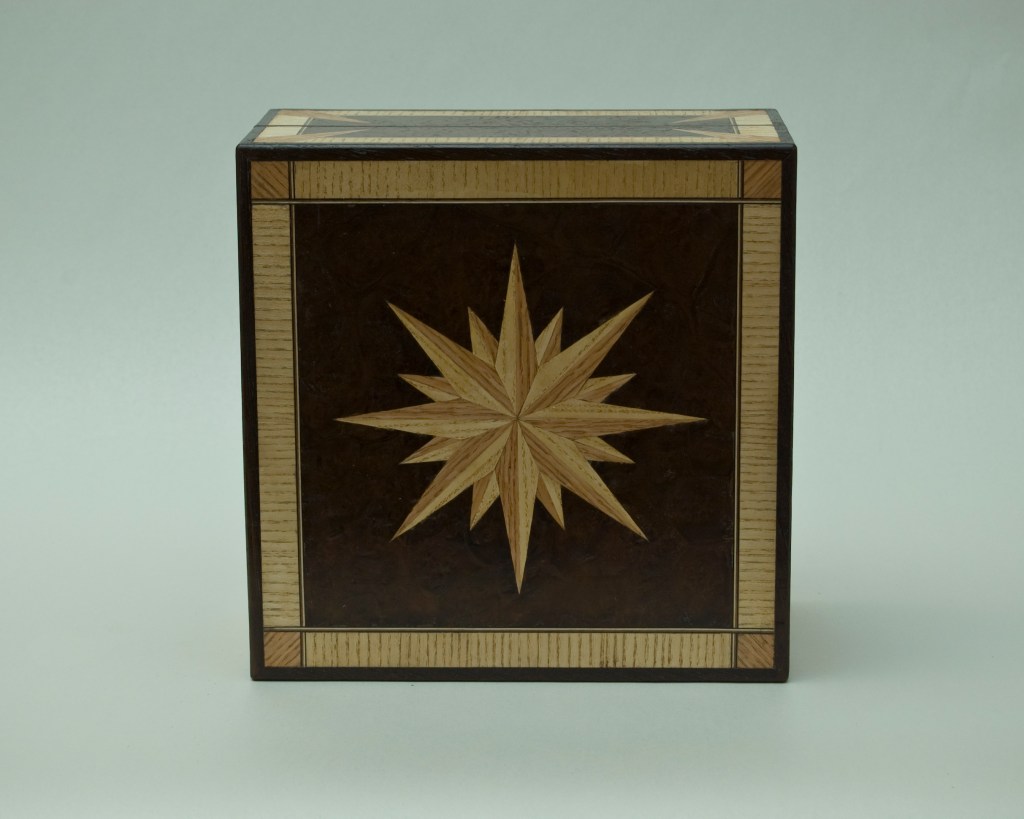 Compass star on lid of wooden box